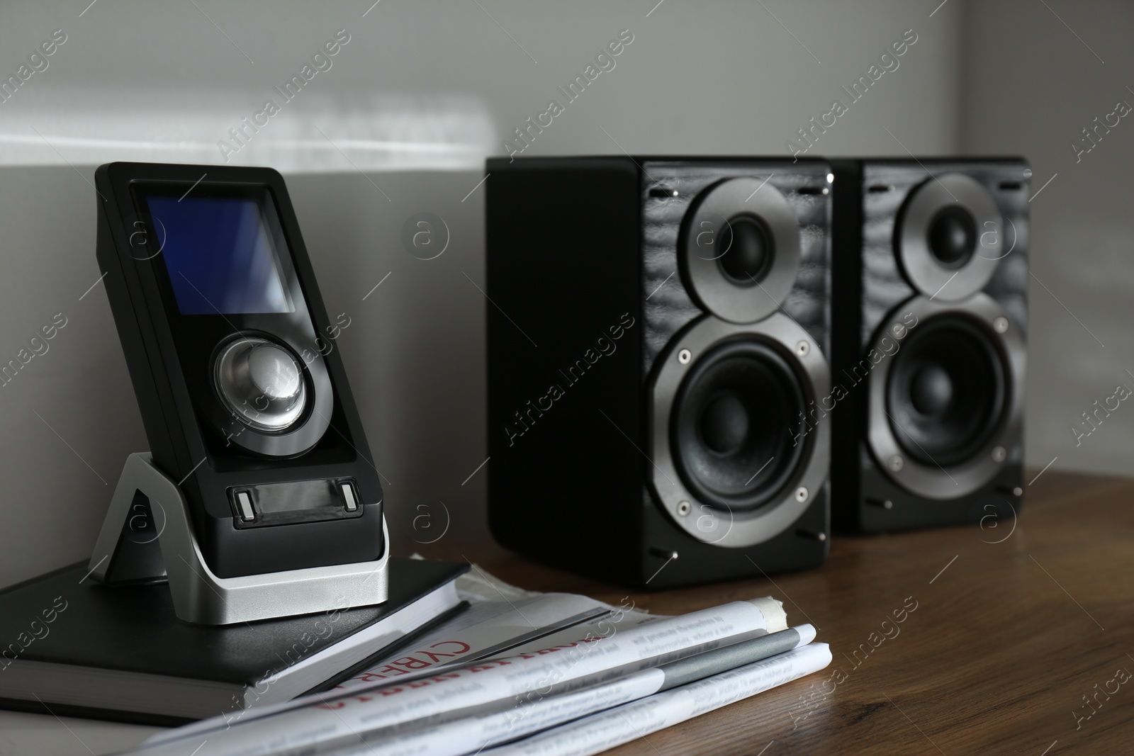 Photo of Modern powerful audio speakers and remote on table indoors