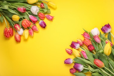 Photo of Beautiful colorful tulip flowers on yellow background, flat lay. Space for text