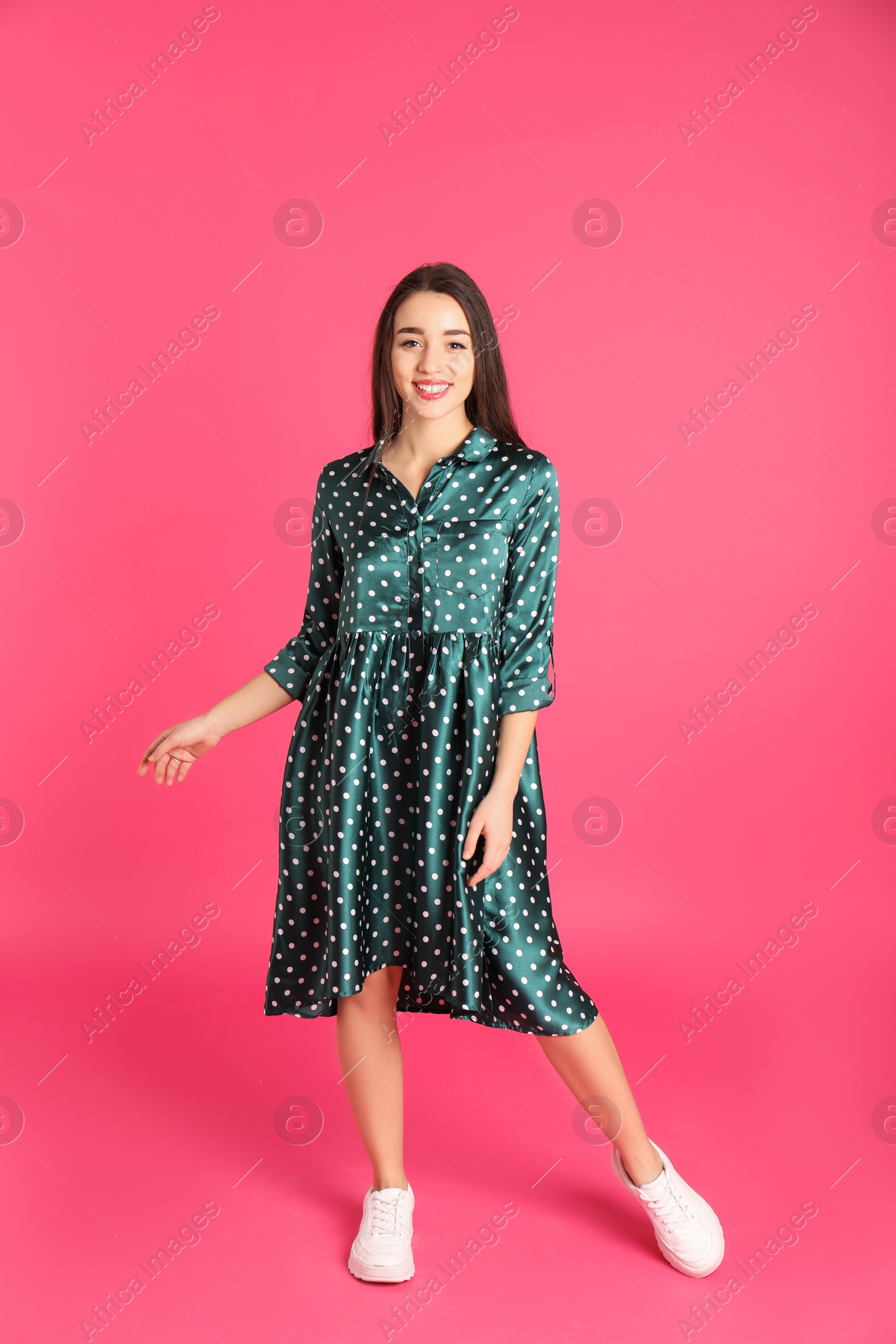 Photo of Portrait of beautiful young woman in stylish dress on color background