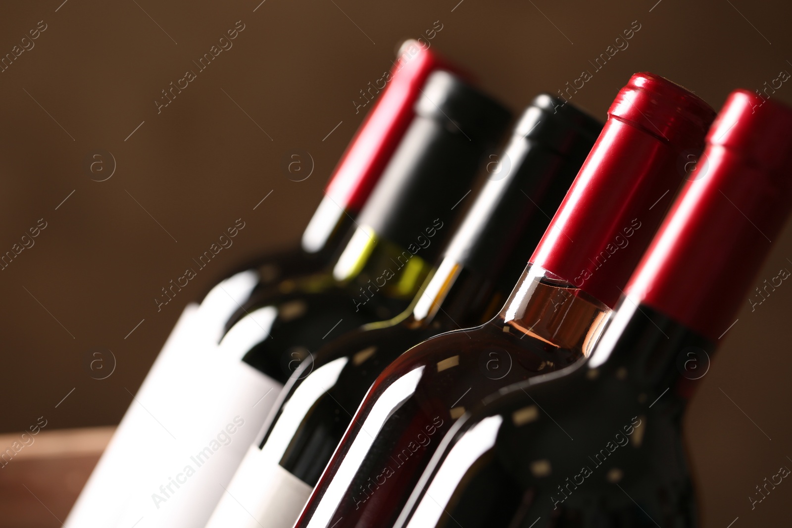 Photo of Bottles of different wines, closeup. Expensive collection