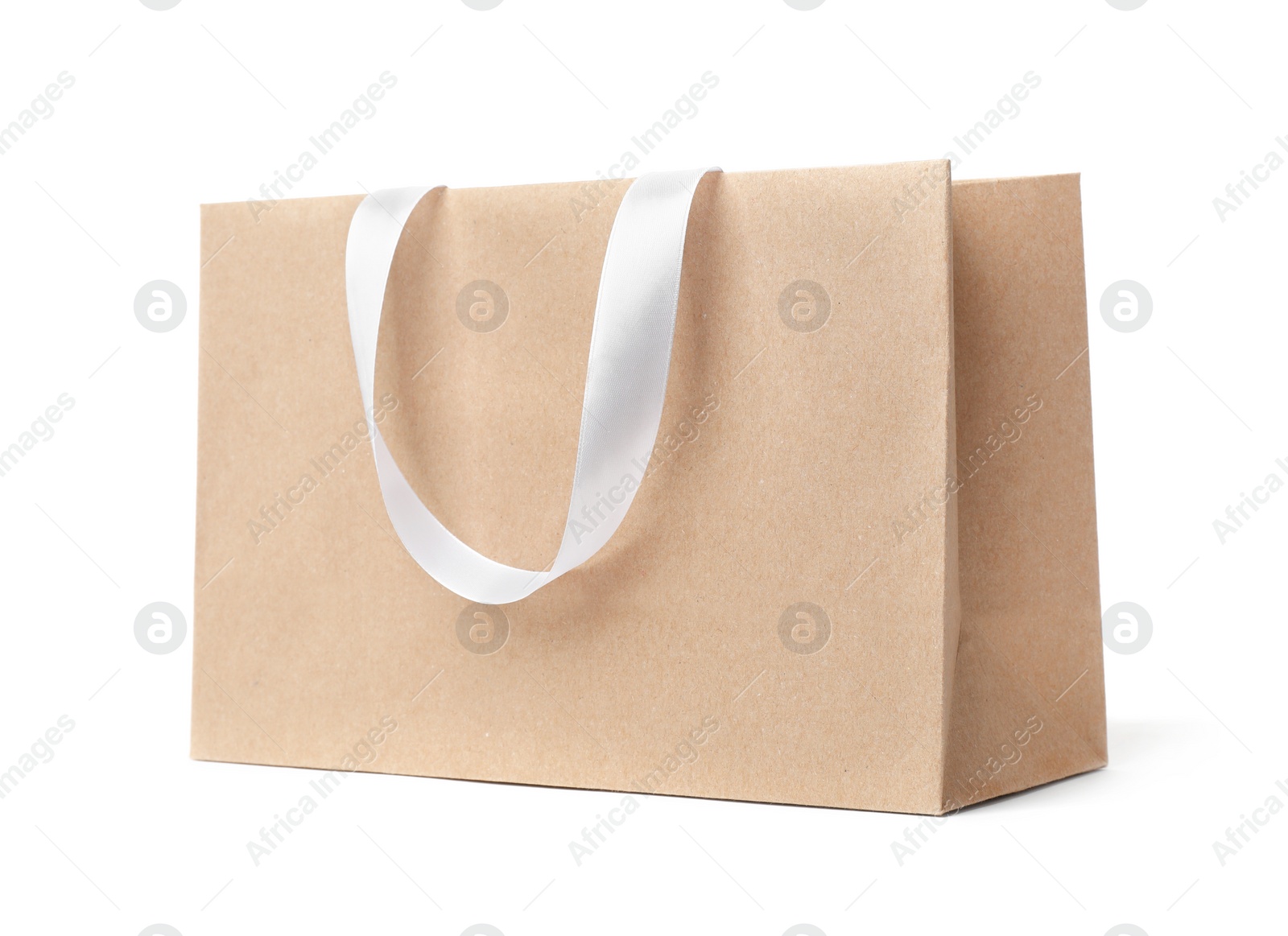 Photo of Paper shopping bag with ribbon handles on white background. Mockup for design