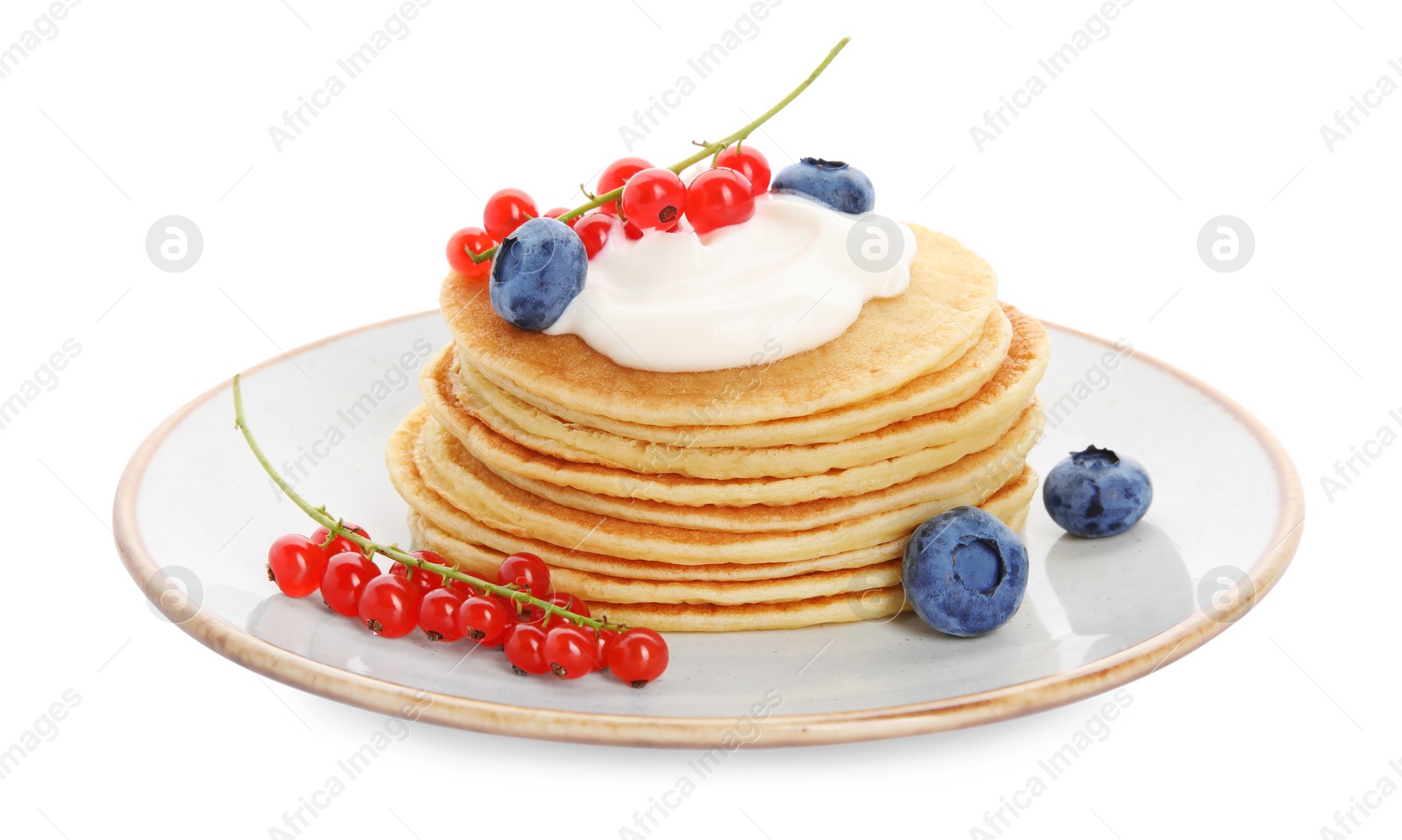 Photo of Tasty pancakes with natural yogurt, blueberries and red currants on white background