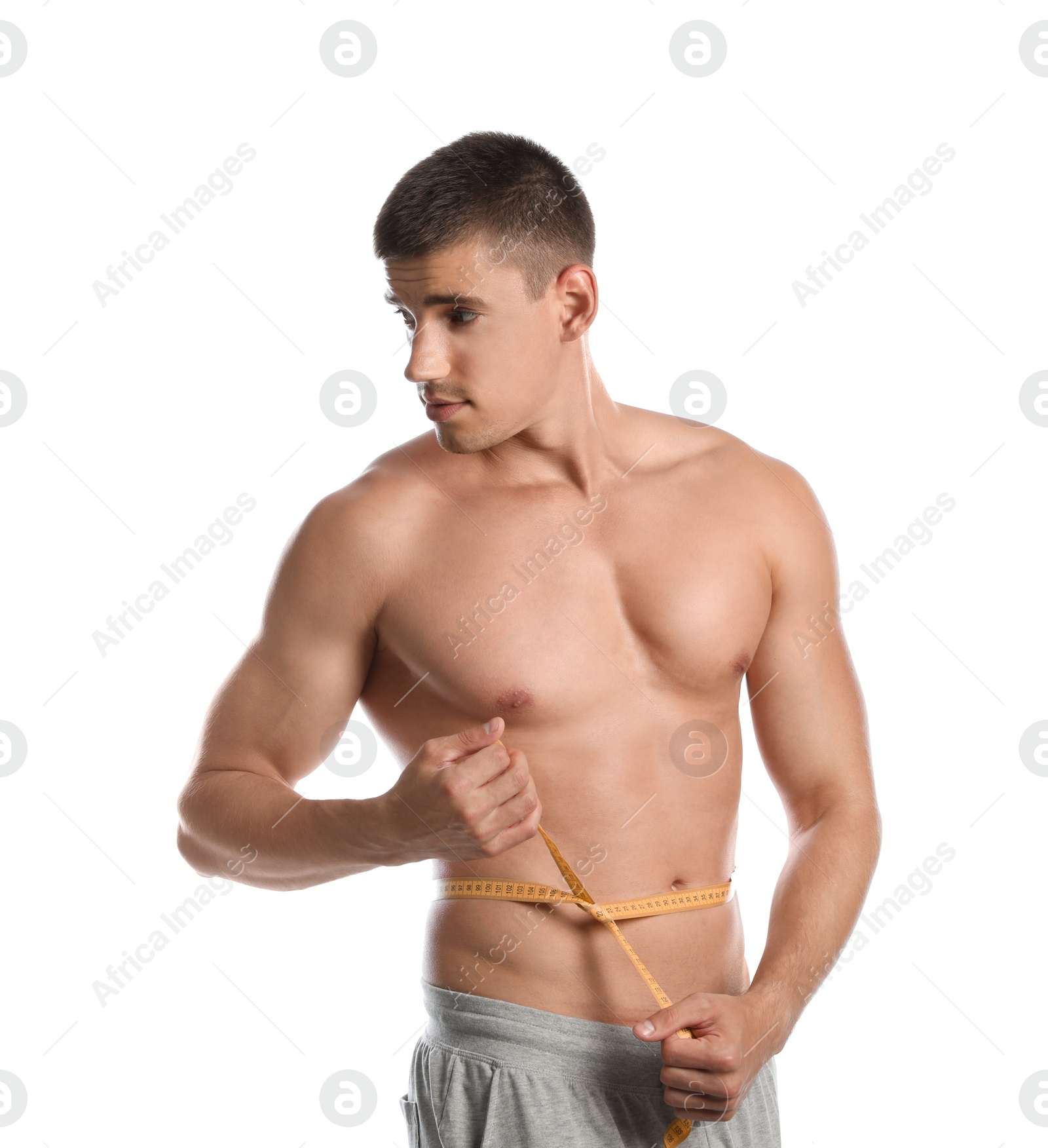 Photo of Young man with slim body using measuring tape on white background