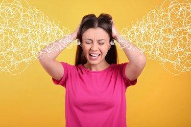 Stressed and upset young woman on yellow background