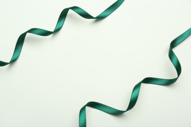 Beautiful green ribbons on white background, flat lay. Space for text