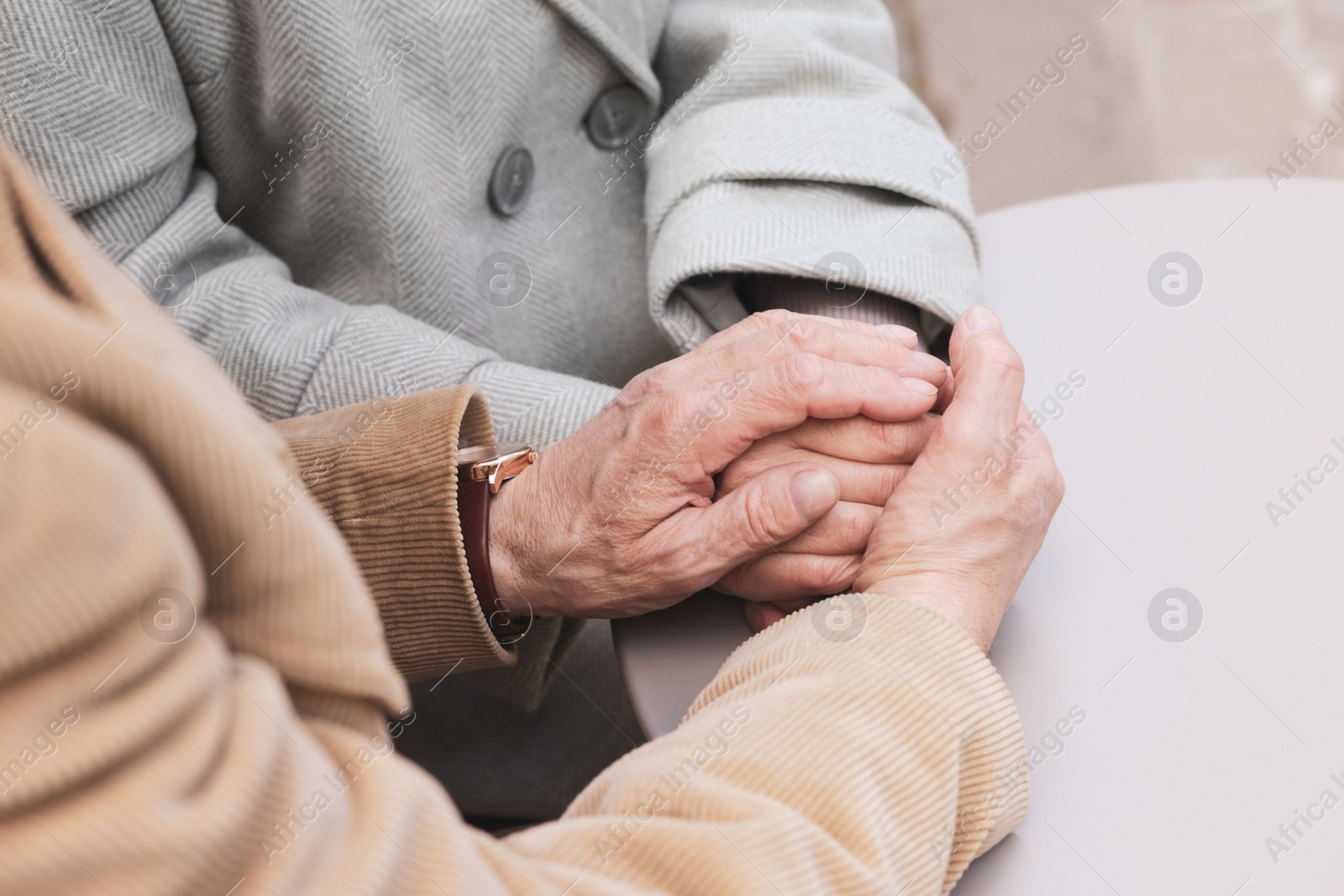 Photo of Affectionate senior couple sitting at table, closeup