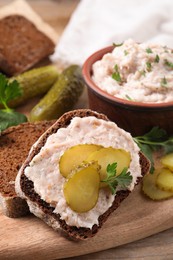 Sandwich with delicious lard spread and pickles on wooden table, closeup