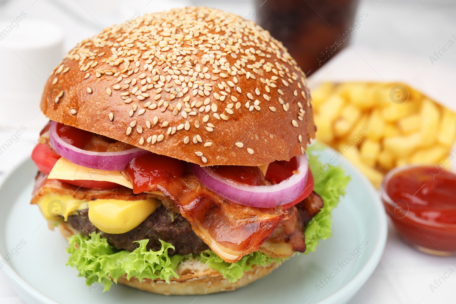 Photo of Delicious burger with bacon, patty and vegetables on table, closeup