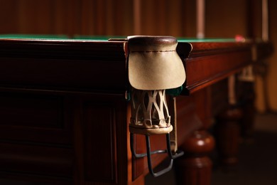 Photo of Stylish billiard table with pocket indoors, closeup