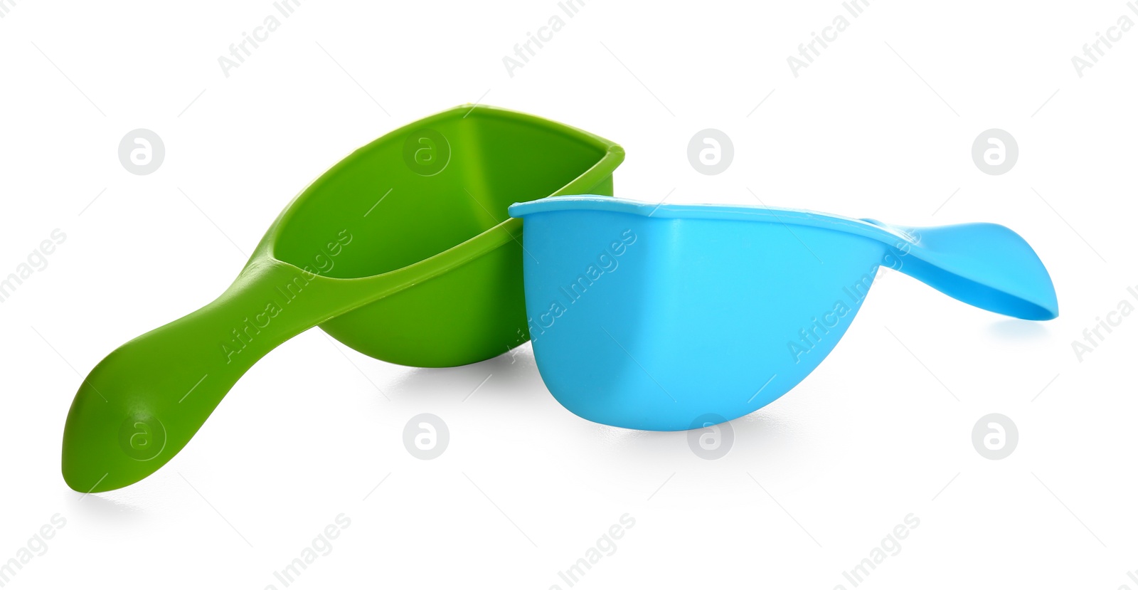 Photo of Plastic scoops on white background. Laundry day