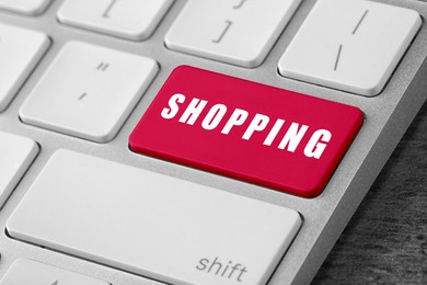 Image of Online store purchase. Red button with word Shopping on computer keyboard, closeup