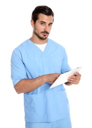 Young male doctor in uniform with tablet on white background. Medical service