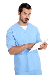 Photo of Young male doctor in uniform with tablet on white background. Medical service