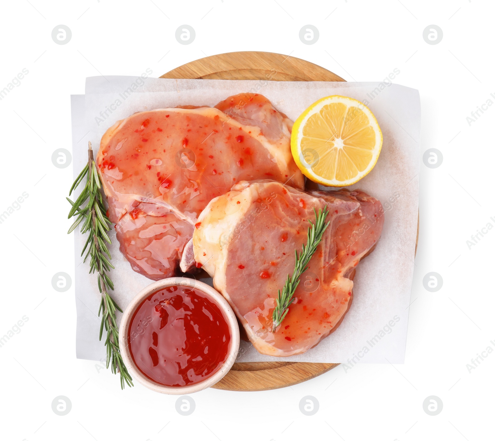 Photo of Board with raw meat, marinade, lemon and rosemary isolated on white, top view