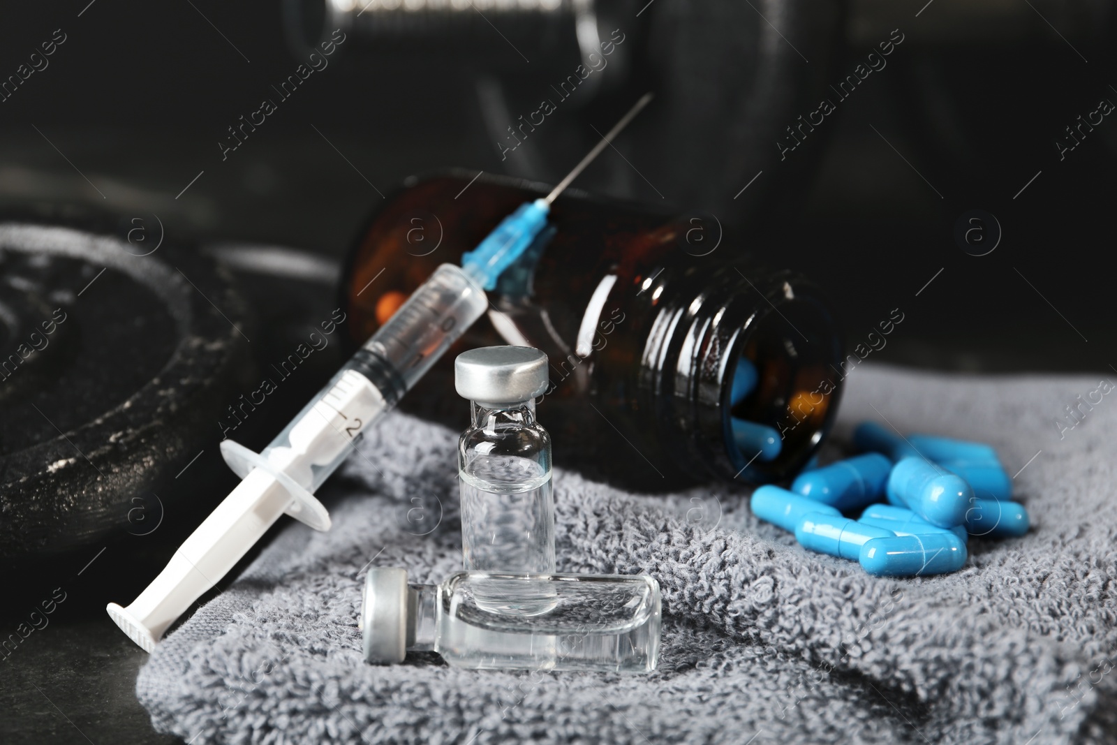 Photo of Different drugs and sports equipment on table, closeup. Doping control