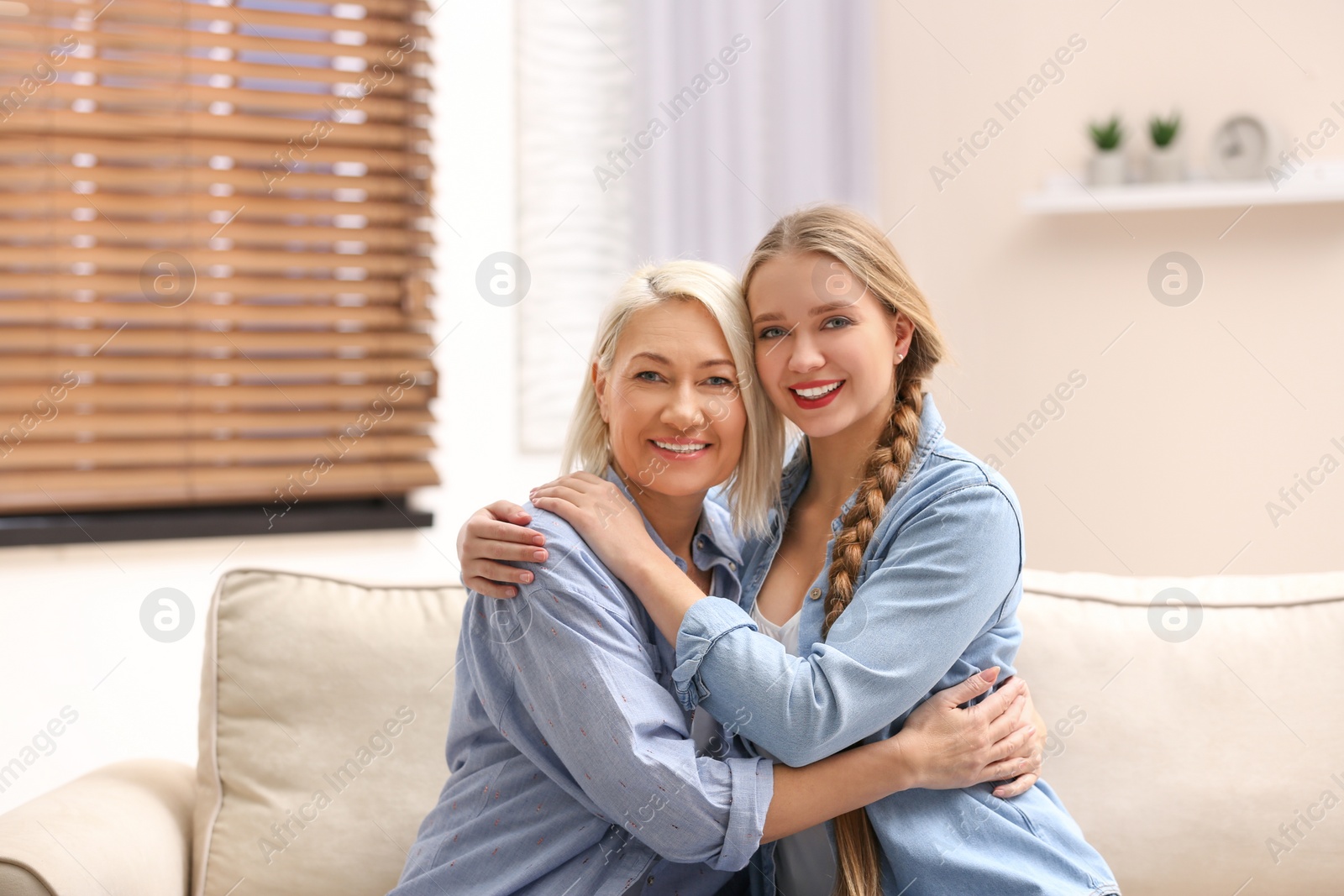 Photo of Mother and her adult daughter spending time together at home