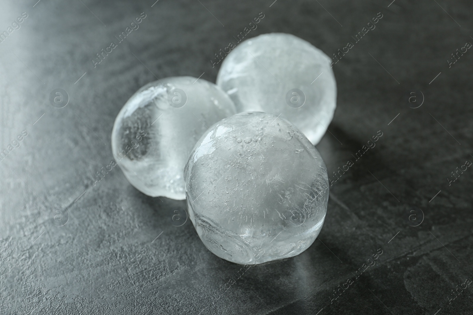 Photo of Frozen ice balls on dark grey table