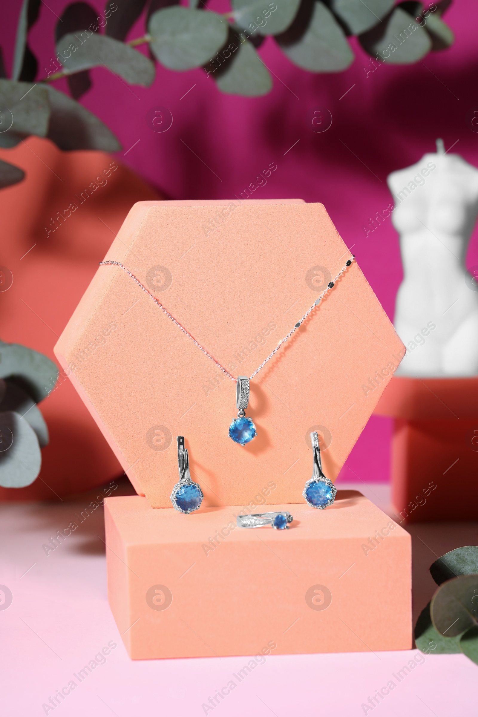 Photo of Stylish presentation of luxury jewelry on pink table