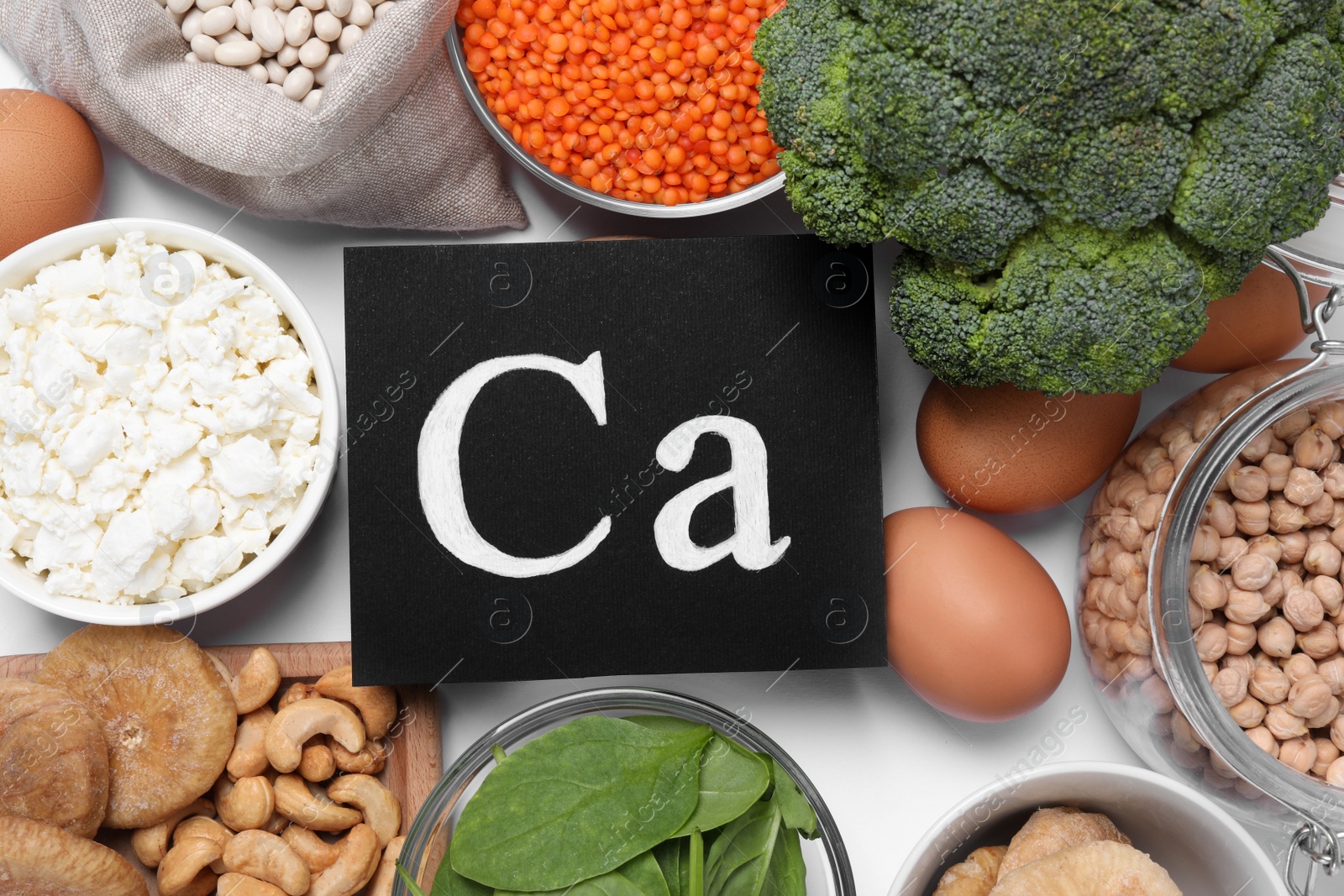 Photo of Set of natural food high in calcium on white background, flat lay