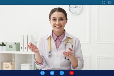 Pediatrician consulting patient online using video chat in clinic, view from webcam