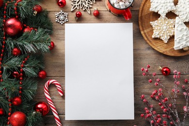Photo of Flat lay composition with blank paper sheet and Christmas decor on wooden table, space for text. Letter for Santa