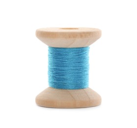 Photo of Wooden spool of light blue sewing thread isolated on white