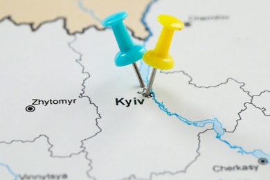 Photo of MYKOLAIV, UKRAINE - NOVEMBER 09, 2020: Kyiv city marked with push pins on contour map of Ukraine, closeup