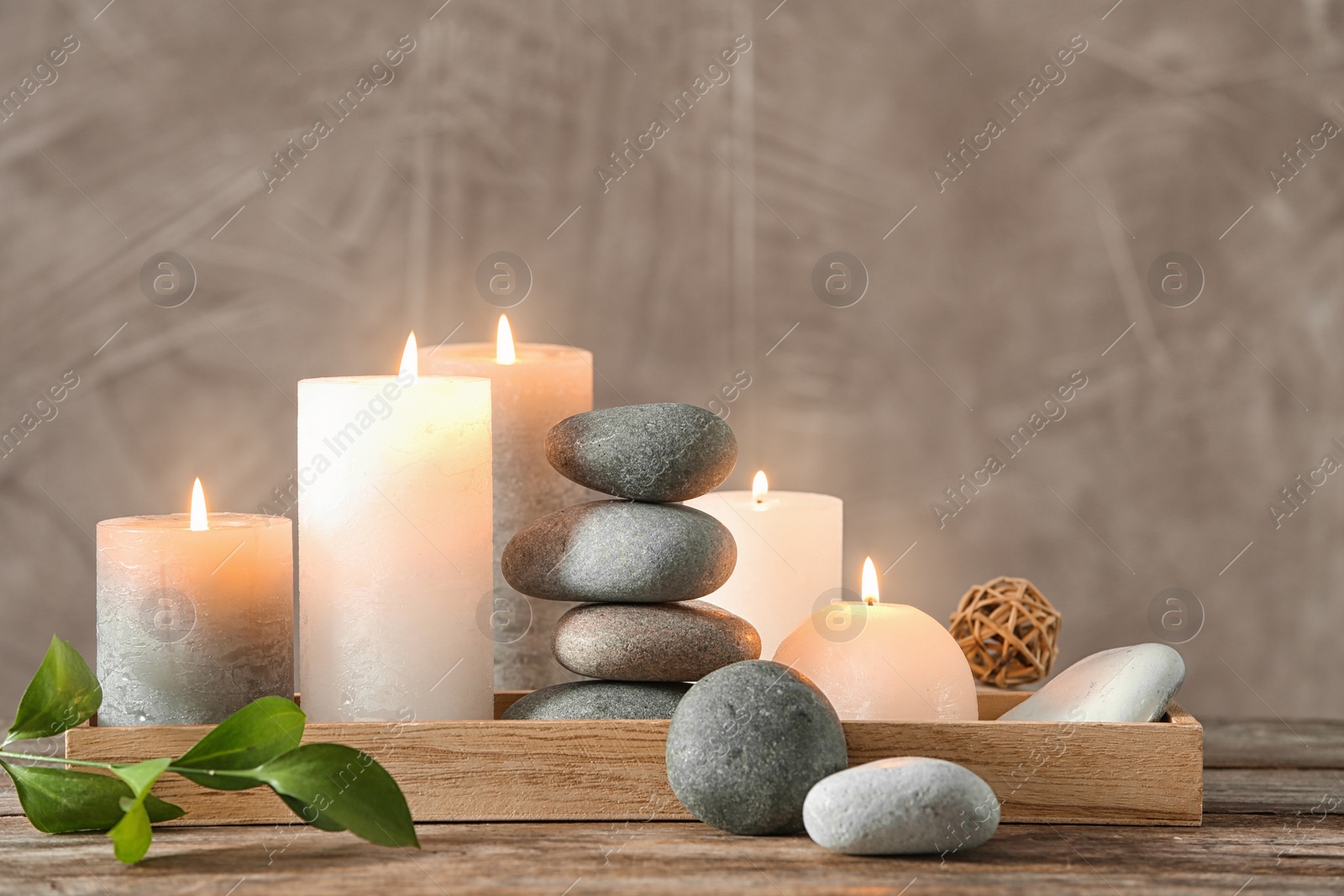 Photo of Composition with spa stones on wooden table