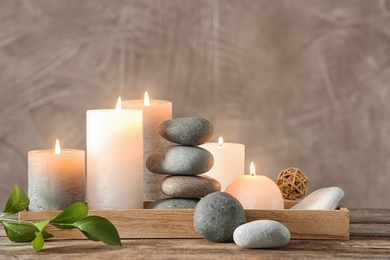 Photo of Composition with spa stones on wooden table