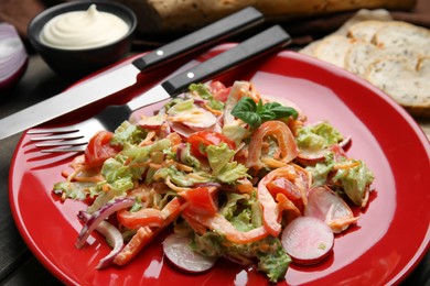 Photo of Delicious salad with mayonnaise served on table, closeup