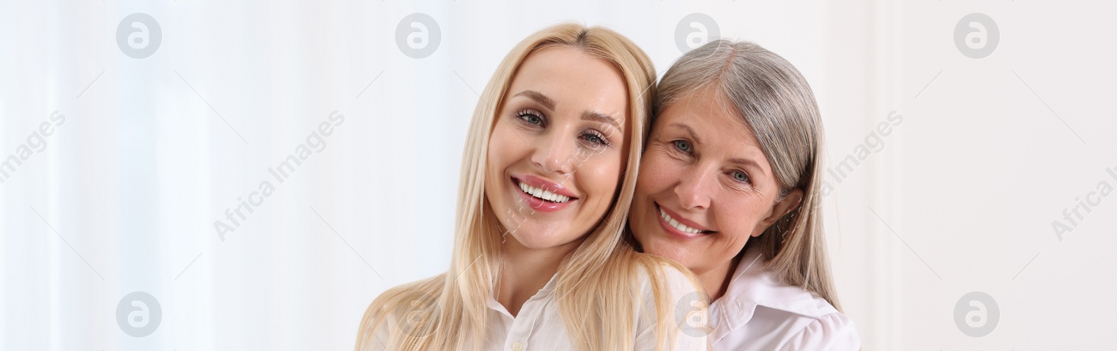 Image of Happy mother and daughter indoors, banner design