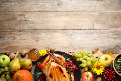 Flat lay composition with turkey on wooden background, space for text. Happy Thanksgiving day