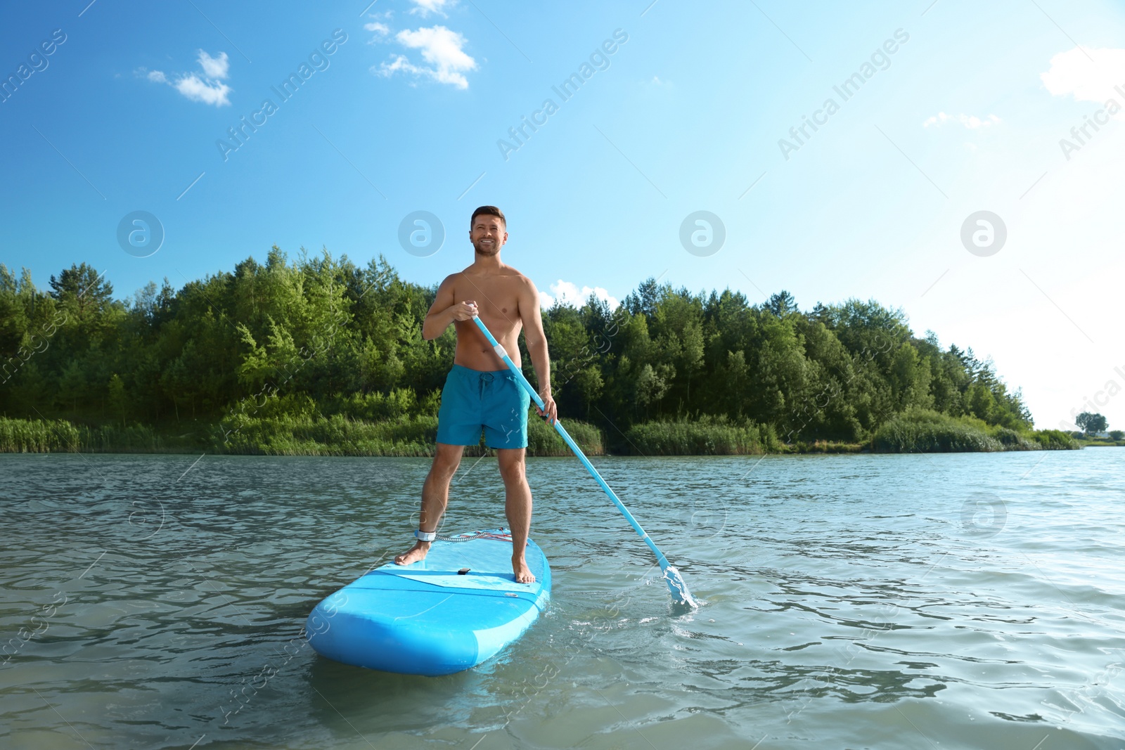 Photo of Man paddle boarding on SUP board in river