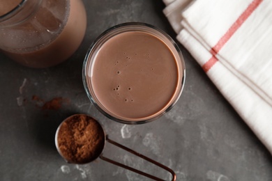 Photo of Flat lay composition with glass of tasty chocolate milk on gray background. Dairy drink