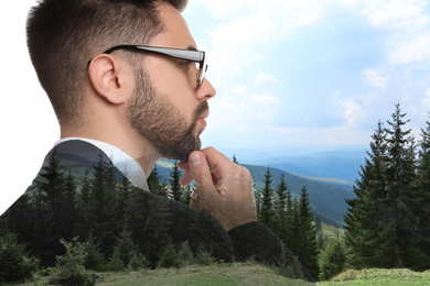 Double exposure of businessman and mountain landscape