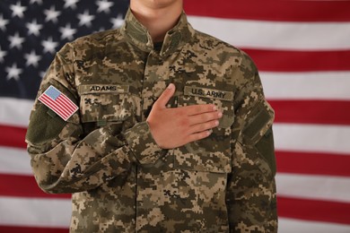 Photo of Male soldier and American flag on background, closeup. Military service