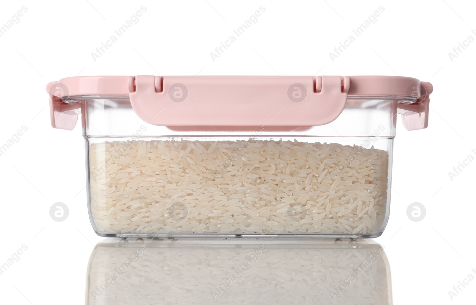 Photo of Box with uncooked rice on white background