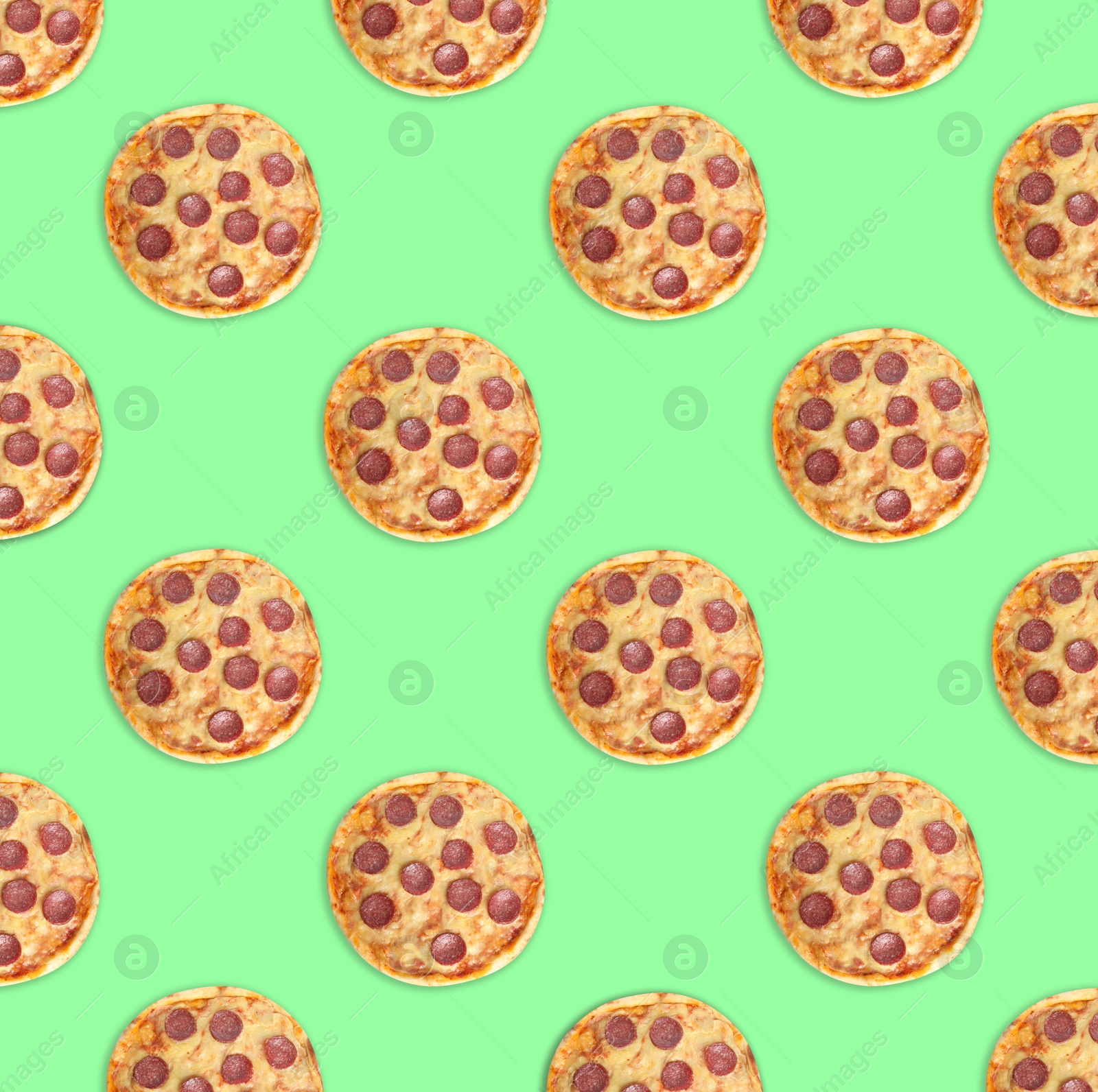 Image of Many delicious pepperoni pizzas on green background, flat lay. Seamless pattern design