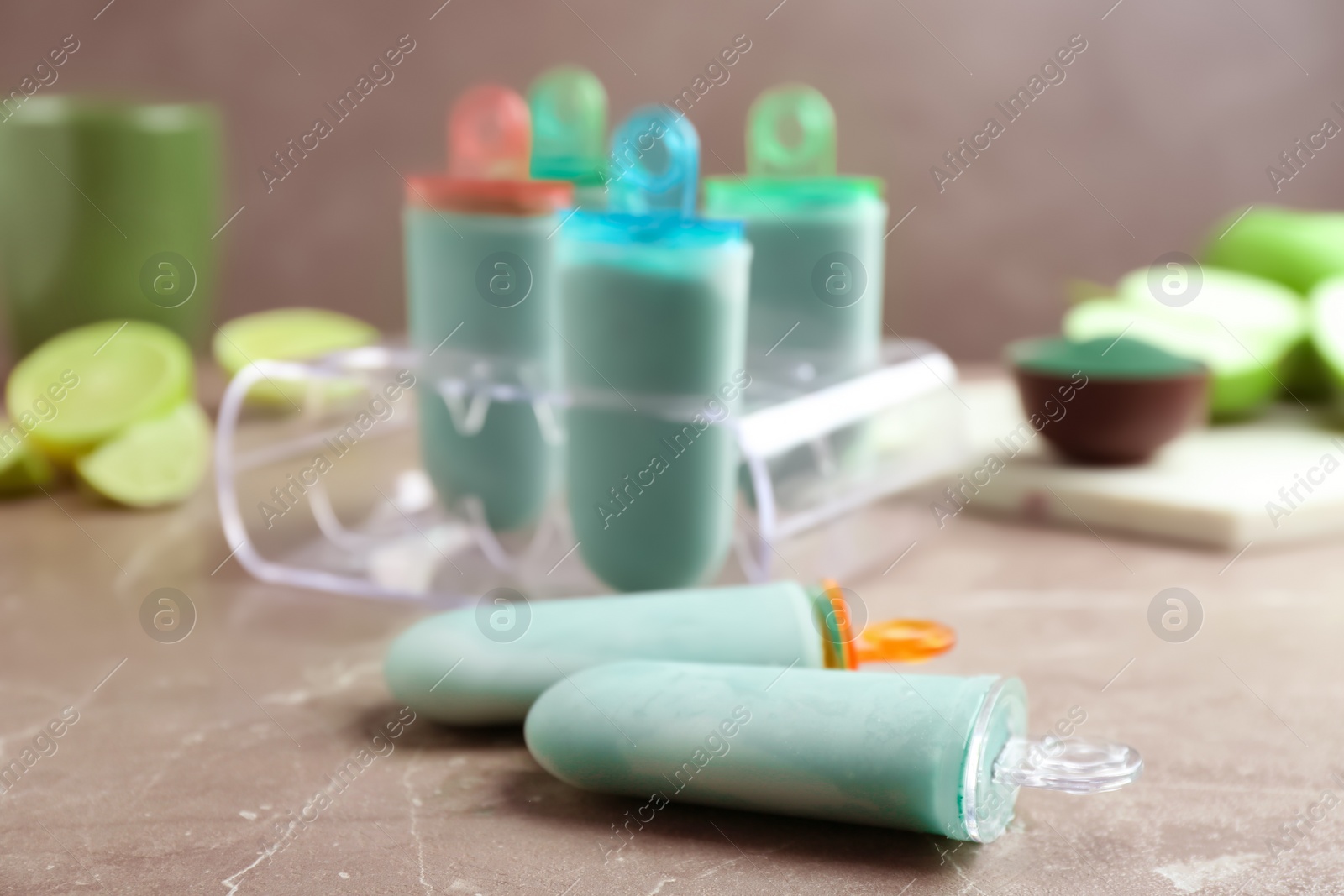 Photo of Delicious spirulina popsicles and ice cream mold on table