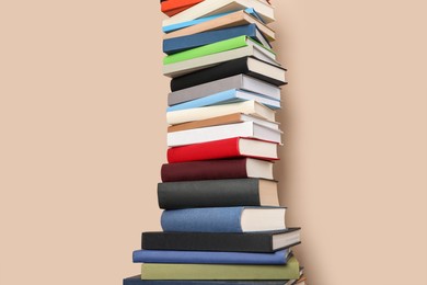 Photo of Stack of hardcover books on beige background
