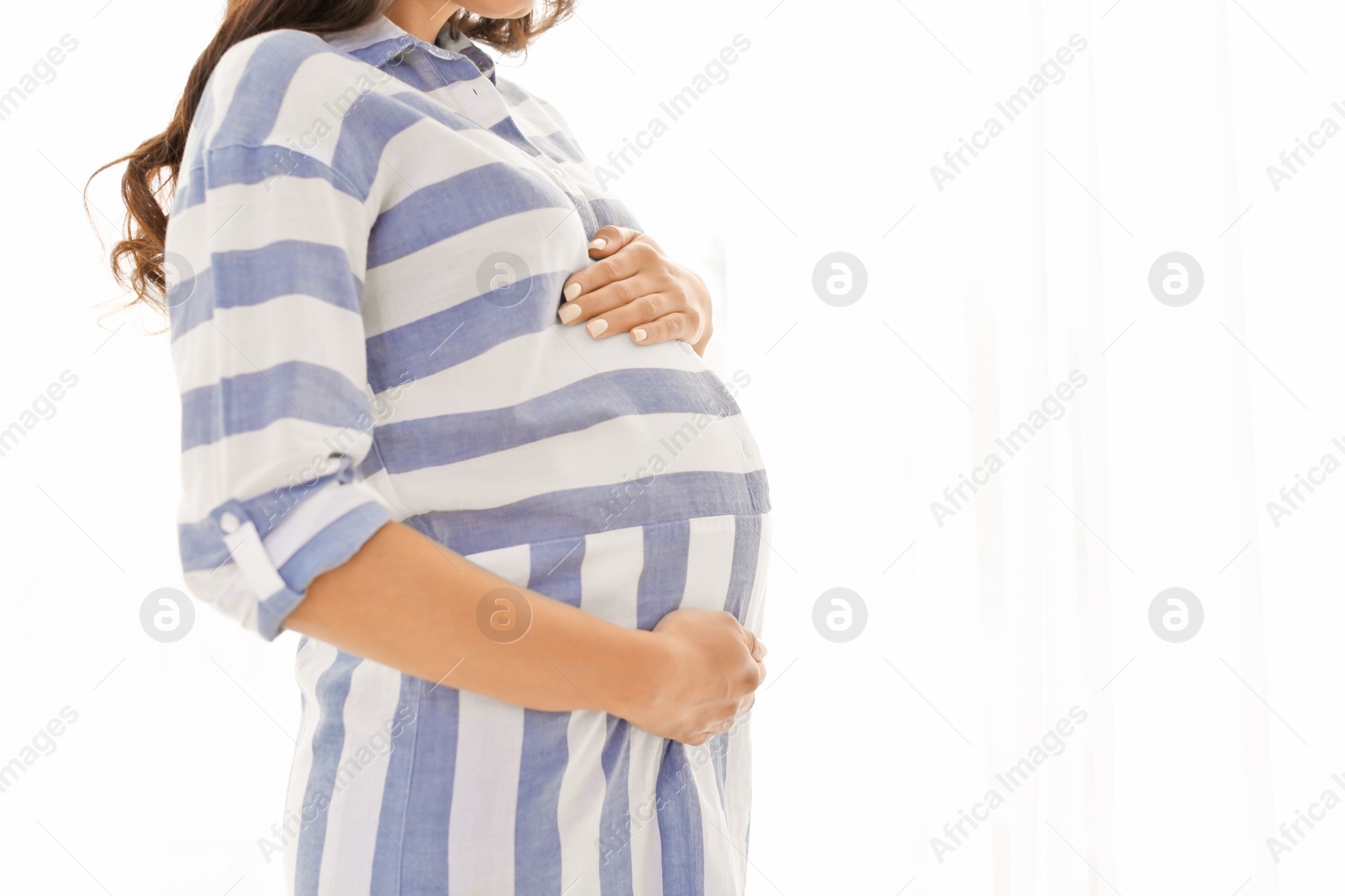 Photo of Beautiful pregnant woman on light background