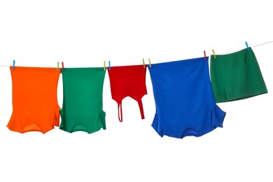 Photo of Different clothes drying on laundry line against white background