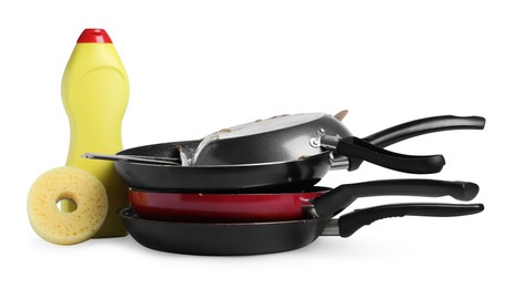 Photo of Stack of dirty kitchenware, dish detergent and sponge on white background