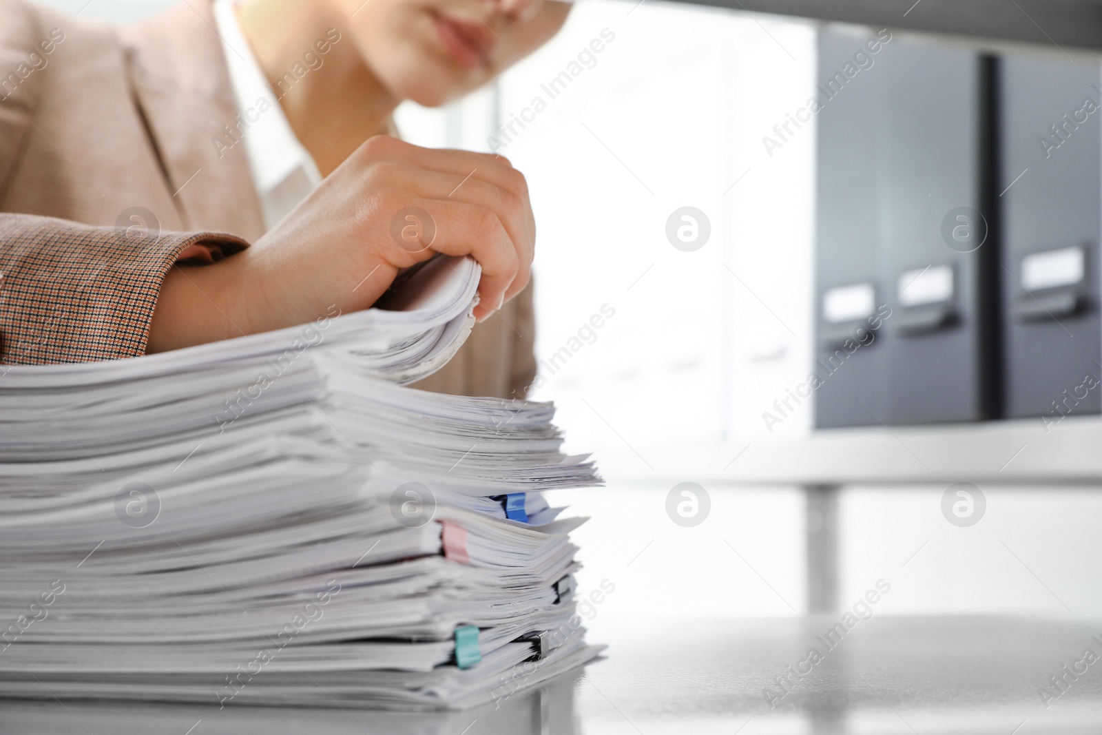 Photo of Woman working with documents in office, closeup. Space for text