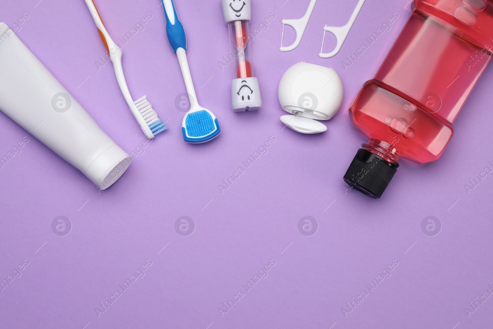 Photo of Flat lay composition with tongue cleaner and teeth care products on violet background, space for text