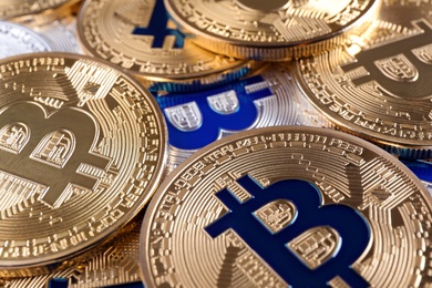 Photo of Shiny bitcoins as background, closeup view. Digital currency