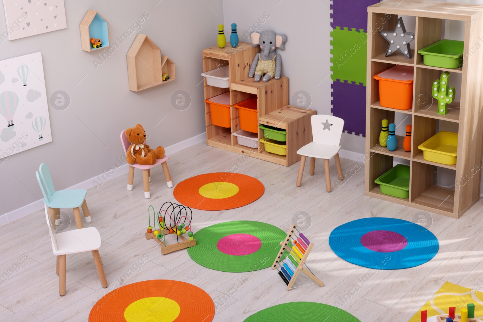 Photo of Child`s playroom with different toys and furniture, above view. Cozy kindergarten interior