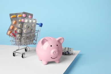 Photo of Piggy bank, pills and money on colorful background, space for text. Medical insurance