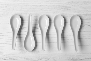 Photo of Flat lay composition with miso soup spoons on white wooden table