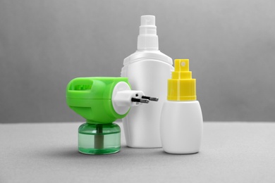 Photo of Set of different insect repellents on grey background